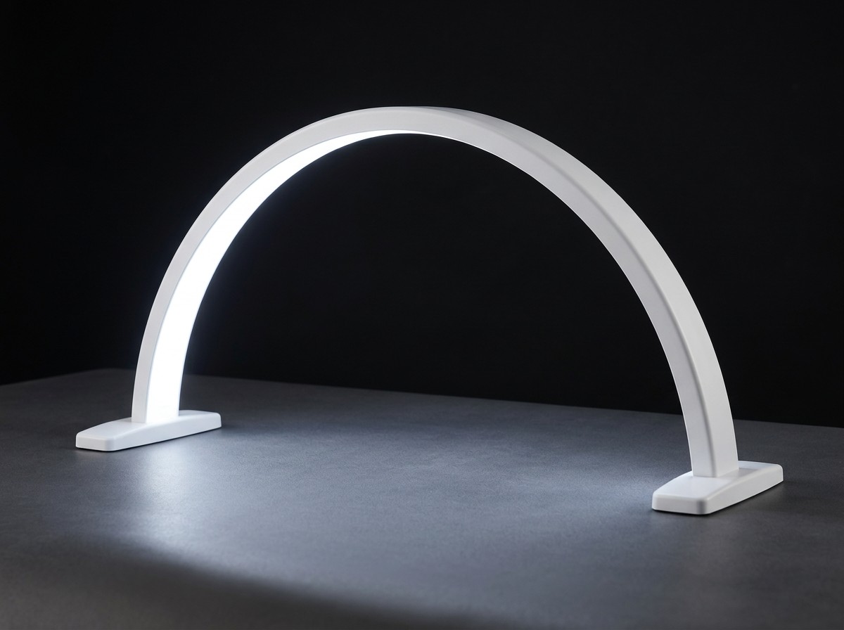White GlowBow Nailmoon arch lamp illuminated in a studio